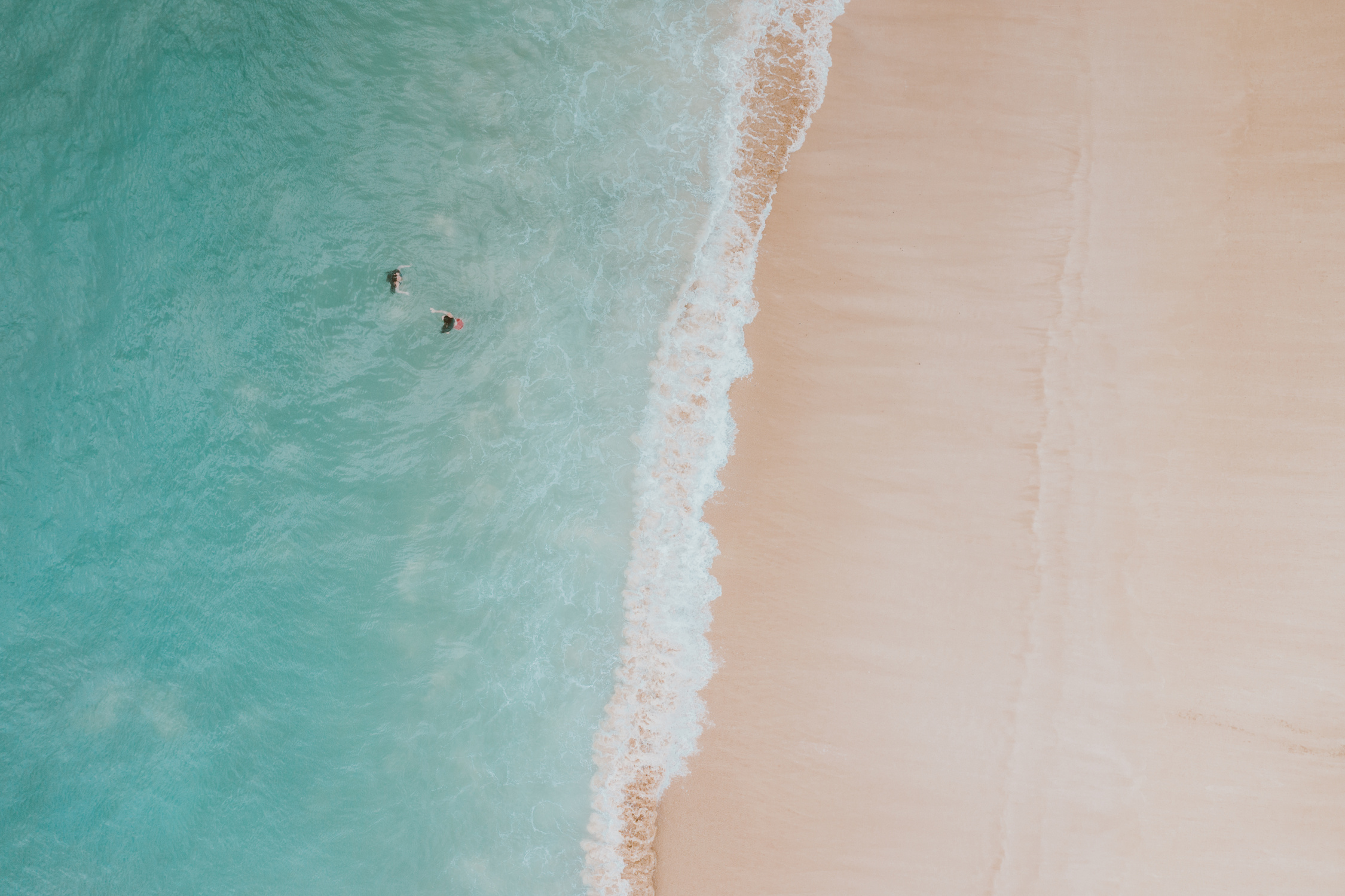 Aerial View of People Swimming on Beach